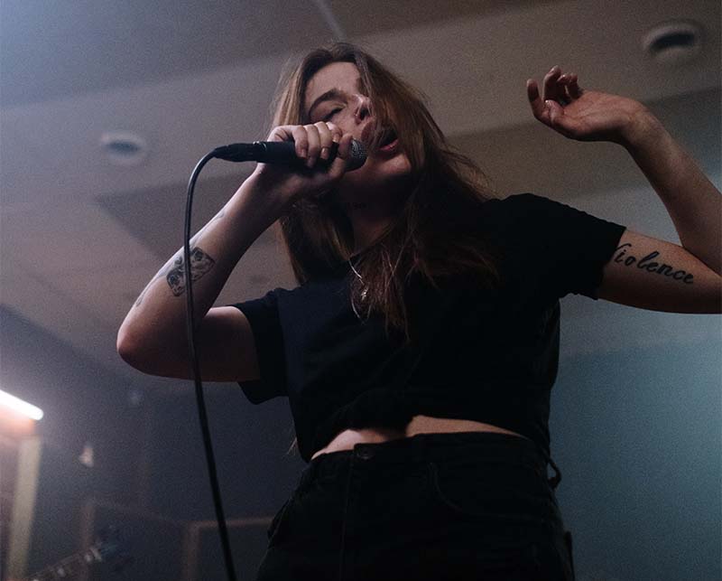 Two hands entwined with an engagment ring on the woman's hand