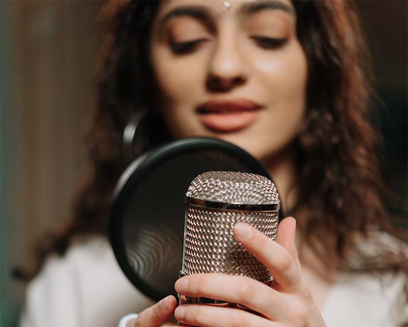 Two hands entwined with an engagment ring on the woman's hand